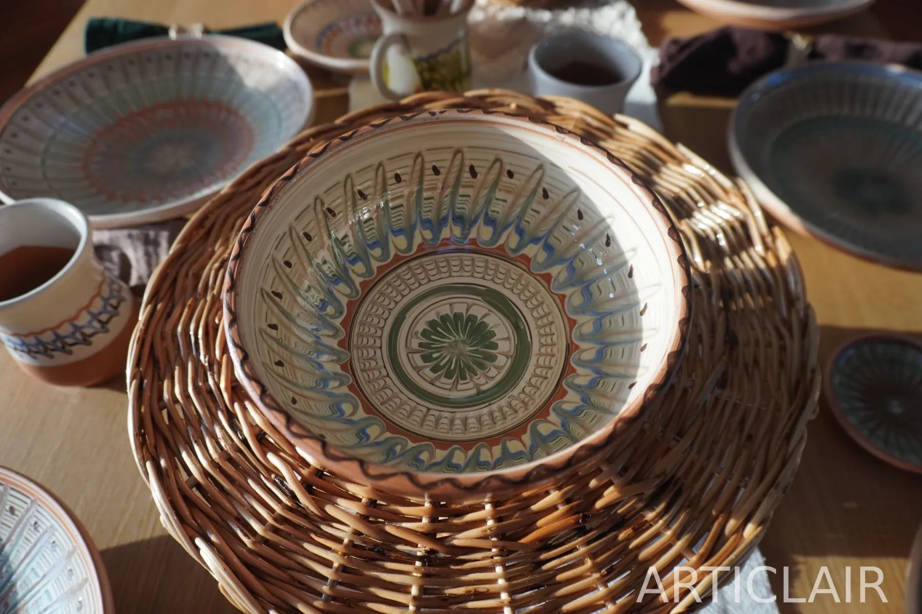 A decorated Horezu bowl with blue-green feathered motifs around the rim