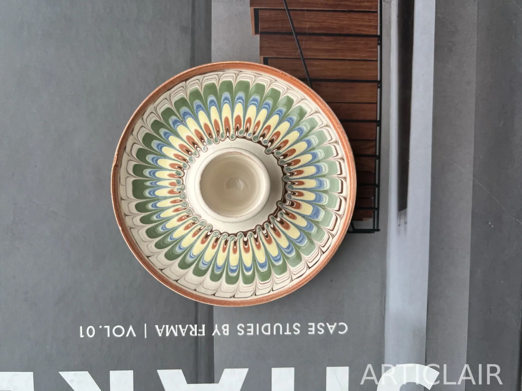 A Horezu bowl with green, blue, and terracotta rays around the inner wall