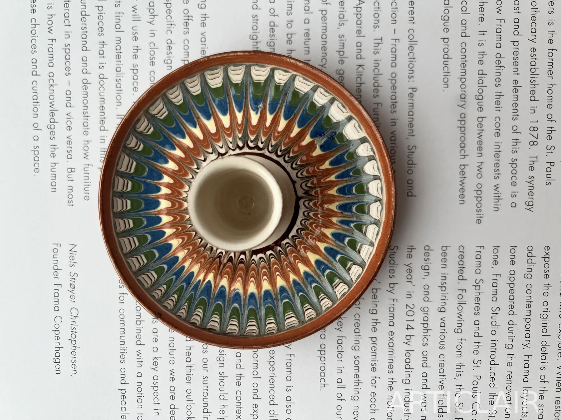 A Horezu serving bowl with a dense ring of blue, green, and terracotta feather motifs