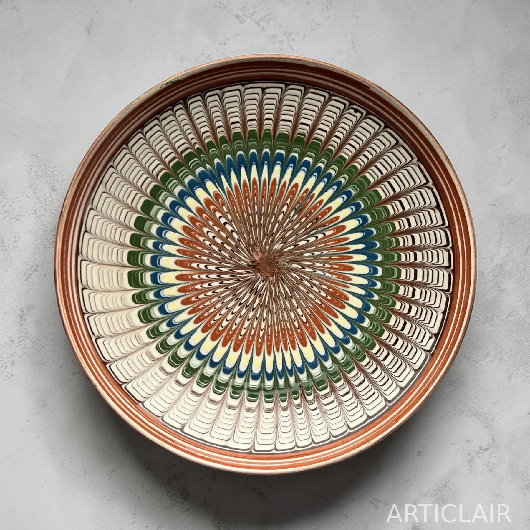 A Horezu plate with concentric rings of feathered brushwork in terracotta, blue, and green