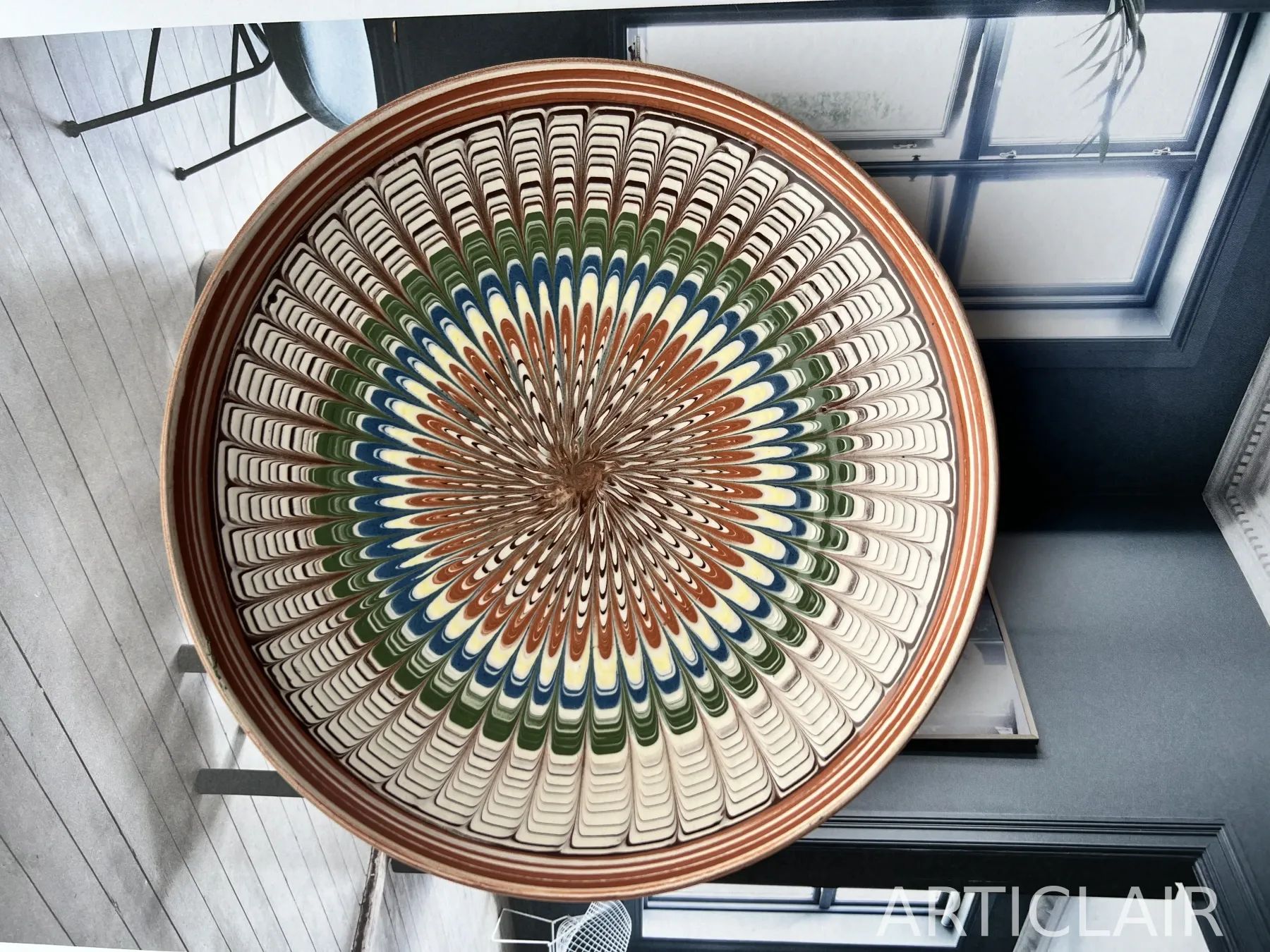 A Horezu plate with concentric rings of feathered brushwork in terracotta, blue, and green