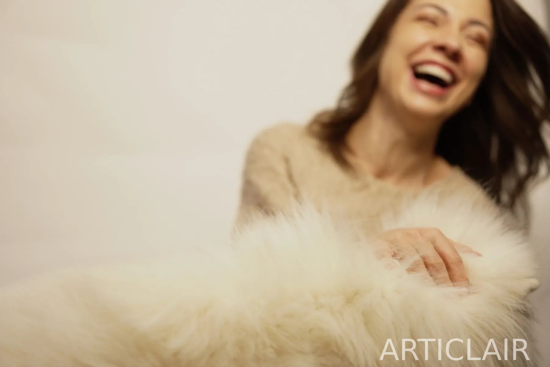 A candid laughing portrait framed through soft shearling texture
