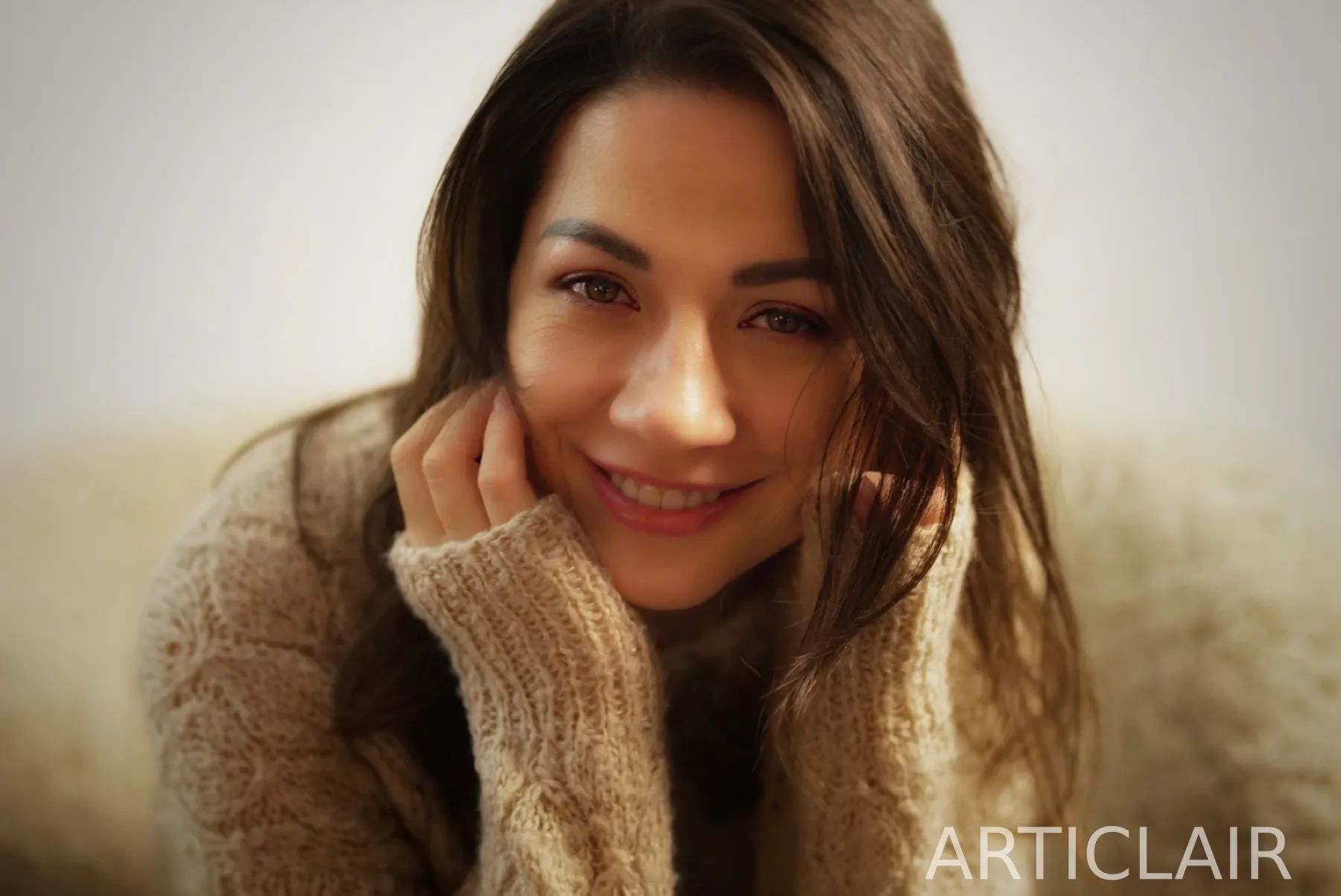 A warm portrait in knitwear with a direct smile toward the camera